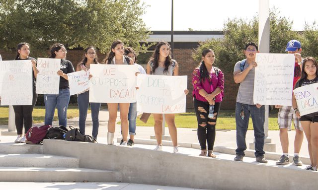 South students from the campus’ Latin American Student Success Organization hold signs outside of the library as they take turns sharing their opinions and experiences regarding DACA during the rally Sept. 14, 2017. 