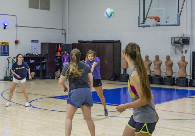 NW student Caitlynn Gonzalez plays the ball as her teammates look on. Around 20 students showed up to participate in intramural volleyball on NW.