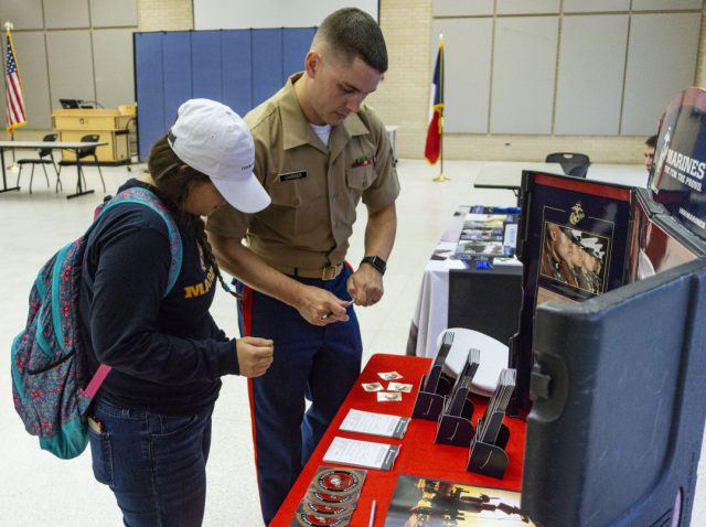 Marines recruiter Staff Sgt. Ryan Carrier informs NW Chritshelle Espinosa about career opportunities in the armed forces Sept. 12.