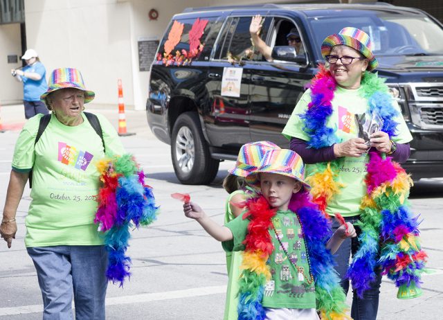 AIDS Outreach Center representatives pass out sunglasses to Tarrant County Pride parade patrons during the 2017 event.