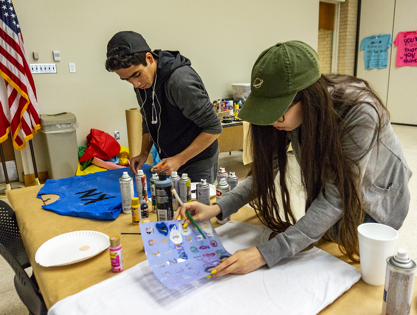 Students create T-shirts with words of encouragement for abuse or assault victims and to spread awareness about violence against women Oct. 18 on NW.