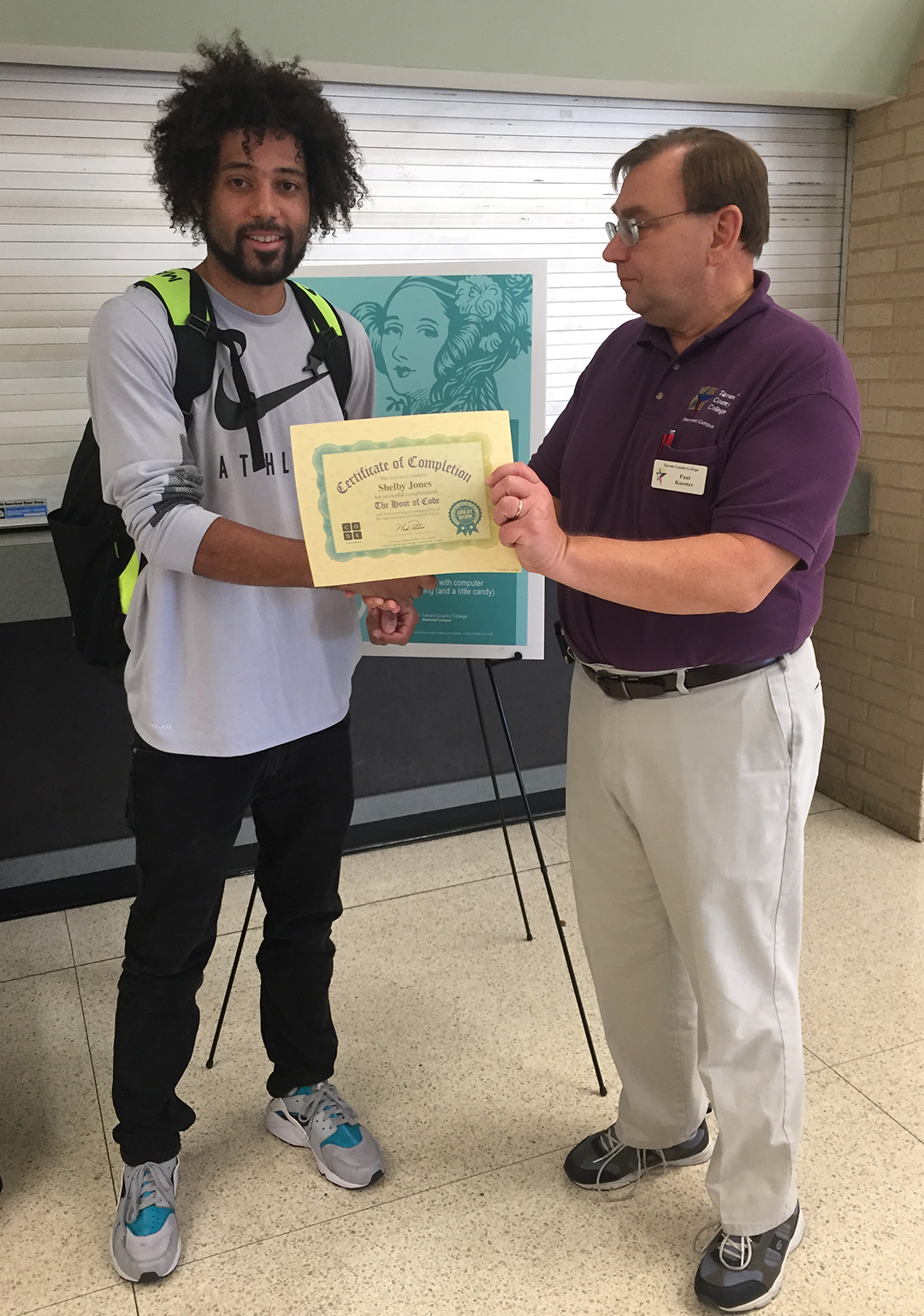NW student Shelby Jones receives a certificate of completion from NW computer science instructor Paul Koester for successfully completing Level 3 in 2017’s Candy and Coding.