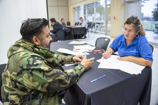 Tarrant County attorney Elsa Marroquin takes down NW student Joseph Sonora’s information during the Texas Lawyers for Texas Veterans Job Fair Oct. 19 on NW.