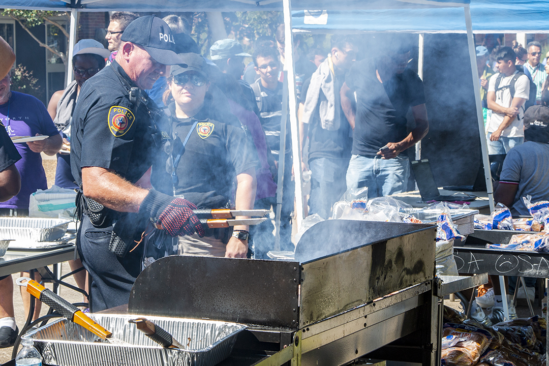 South Campus police officers dish up hot dogs and hamburgers as part of South’s Cookout with the Cops event Oct. 4. The event is a way for students, faculty and staff to mingle with campus police officers.