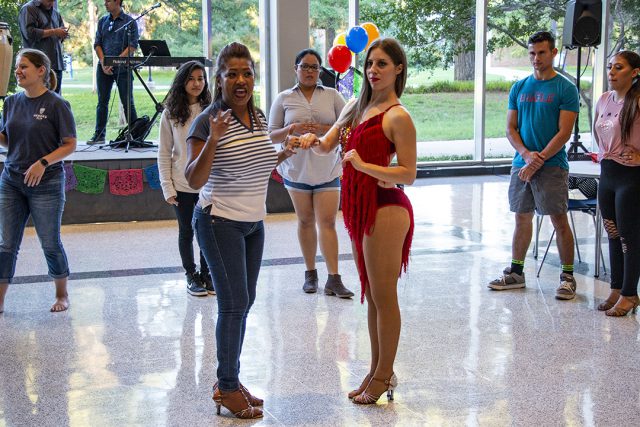 Dance instructors teach students steps to traditional Latin dances at Salsa y Salsa Sept. 27 on South. Attendees listened and danced to live music while learning various styles.