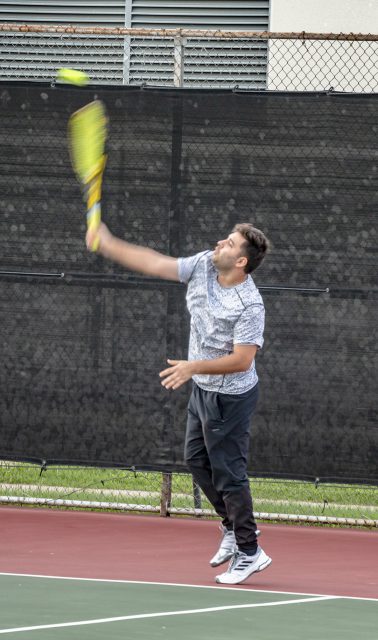 A NW student lines up his shot for a serve during intramural tennis Oct. 11 on NW Campus.