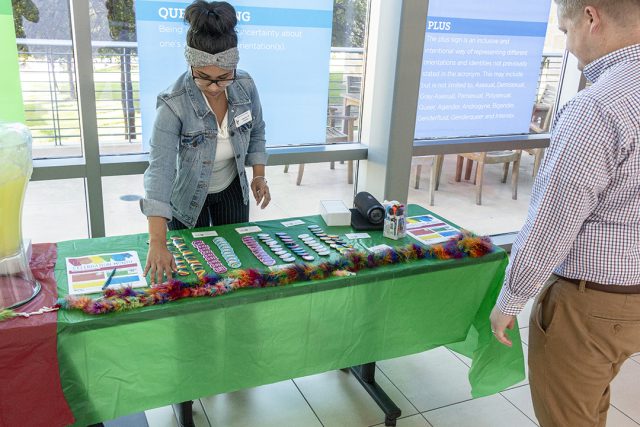 TR student development coordinator Angelica Cuellar sets up a table in preparation to hand out goodies and information during the event Oct. 11 on TR.