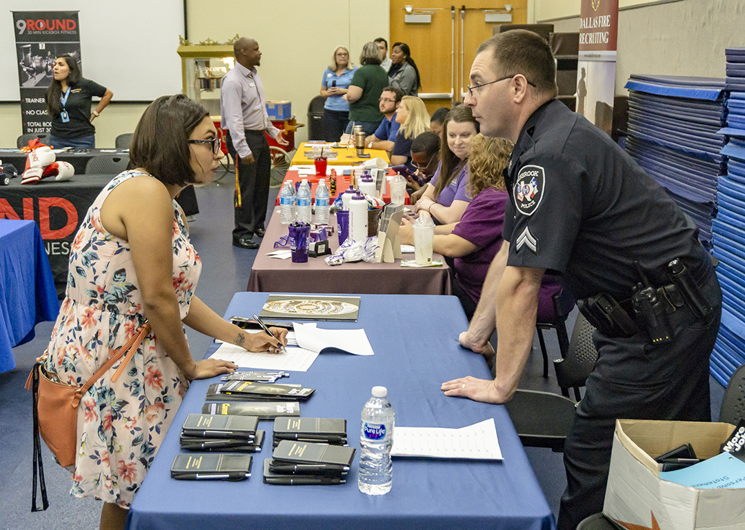 NW student Lydia Pena talks to Benbrook Police Department Detective W. Beverly about employment opportunities Oct. 4 on NW Campus.