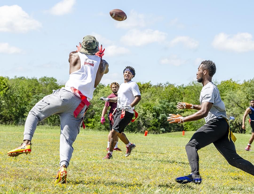 SE student Antonio Wauer throws a long pass as his teammates, SE students Jose Decruise and Nick Nunnally, look on during SE intramural flag football Oct. 4.