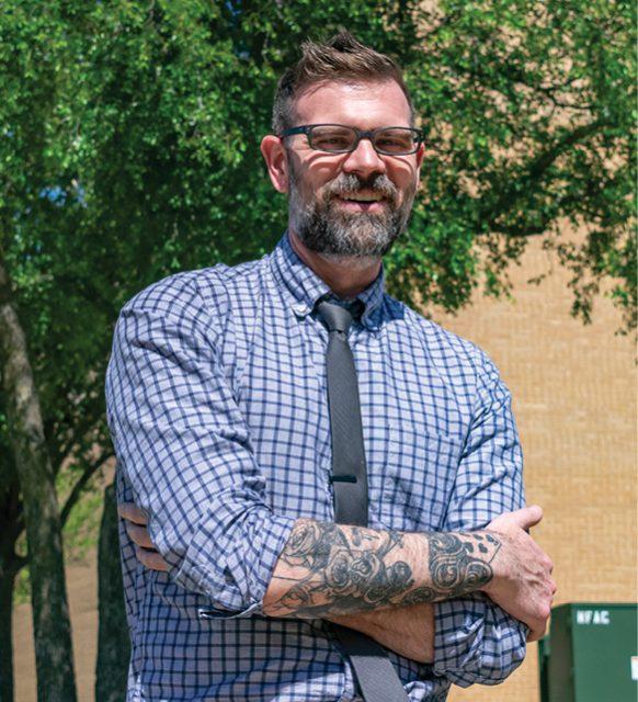 NE English instructor Richard Kingsley sports tattoos and defies the traditional expectation that someone can’t have tattoos while working in a professional position. Photo by Christian Garza/The Collegian