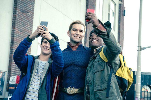 Homelander, played byAnthony Starr, stands and poses with his young fans. He is the equivalent to this universe’s Superman, and is the number one threat to “The Boys” due to his superpowered abilities. Courtesy Amazon Studios/Photos by Jan Thijs