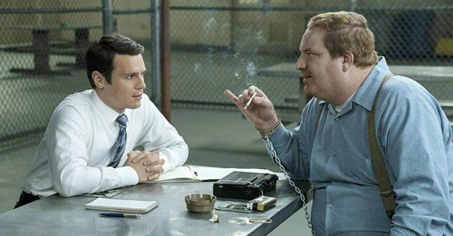 Jonathan Groff portrays FBI Agent Holden Ford (left) as he interviews Jerry Brudos the Shoe Fetish Slayer, played by Happy Anderson in “Mindhunter.” Photo courtesy Patrick Harbron/Netflix