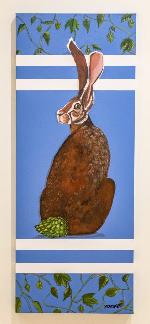 Eddie Brassart’s “Hops” is an acrylic on canvas depicting a crouching rabbit gazing over its shoulder. Photo by Joseph Serrata/The Collegian