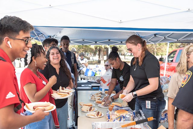 Photos by Joseph Serrata/The Collegian. Students and faculty share laughs while being served by volunteers during the annual Cookout with the Cops event on South Campus.