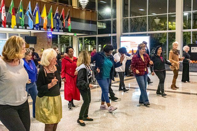 Continuing Education and Engagement program students dance to the Cha Cha Slide during Senior Bash Nov. 15 on South Campus. The event featured a Luby’s catered dinner, CEE class-themed trivia games, a raffle and oldies music.