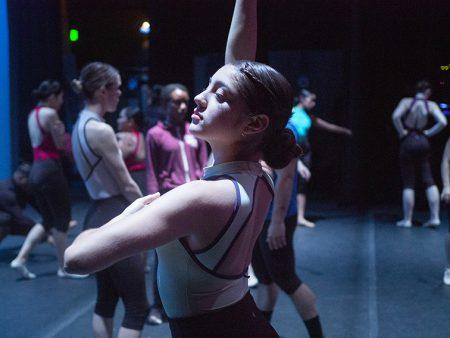 Nelly Garza and other members of the troupe warm up backstage to prepare before “Heart Echoes,” NE’s fall 2019 dance concert, begins.  