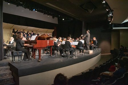 Photo by Vu Nguyen/The Collegian. NW Chamber Orchestra and Choir takes the stage while NW instructor of music Benson Lee conducts them during a performance of Joe Hisaishi’s musical works.