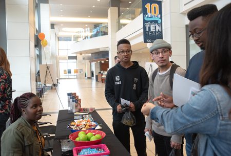 Photo by Joseph Serrata/The Collegian. Representatives of MHMR of Tarrant County inform TR students about the resources available for those in need during the Hunger and Homelessness Awareness Week Resource Fair Nov. 21.