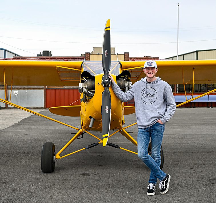 Photo by Joseph Flores/The Collegian. NW student Kale Burks shows off the Legend Cub propeller plane, which he flies to classes on NW Campus. The aviation student has been training since age 15.