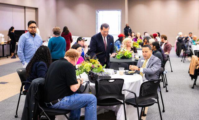 TR continuing education & engagement executive director Robert Munoz talks with peers at a table Feb. 13 during The State of LatinX Civil Rights on TR Campus.