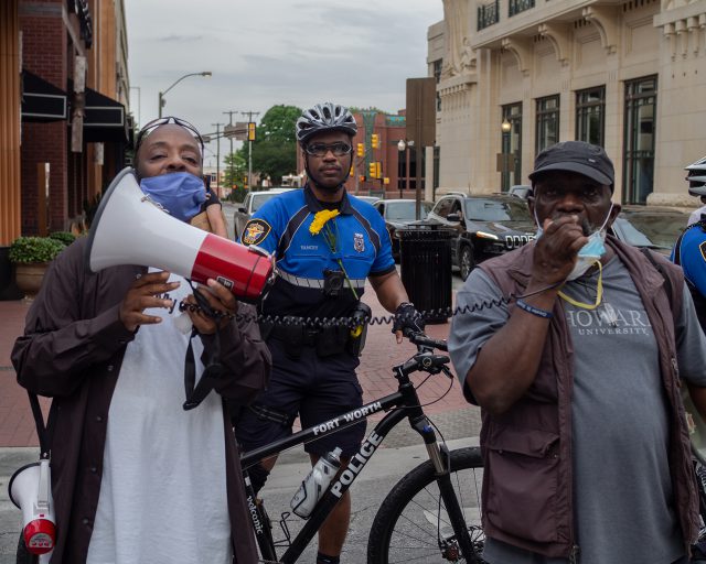 Two leaders from United My Justice lead a group in chants in front of the Bass Hall with Fort Worth police officer June 1. Photo by Jonathan Johnson/The Collegian
