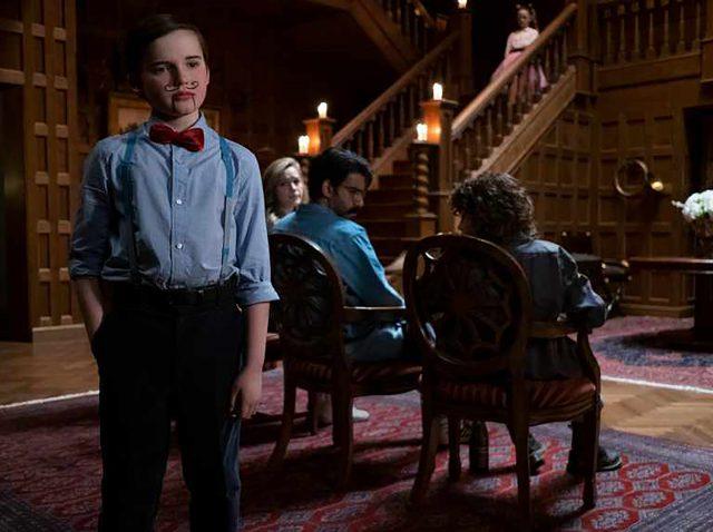 Photo Courtesy of Netflix
Miles and Flora play story time while being possessed by the ghosts of their formal
governess Rebecca Jessel and her overprotective boyfriend.