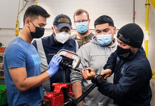 Students learn how to replace ball joint bushings in a hands-on learning session
supervised by instructor Orlando Grijalva.