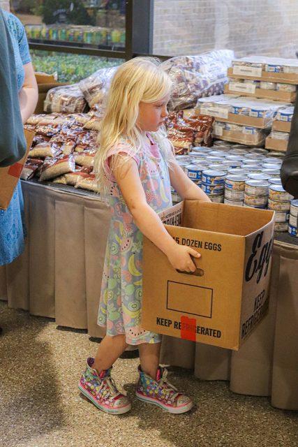 Alex Hoben/The Collegian
A child carries a box around looking at the produce on display at the Fresh Food Market on NE Campus. NE, South, NW and SE have monthly produce markets available to registered students. 