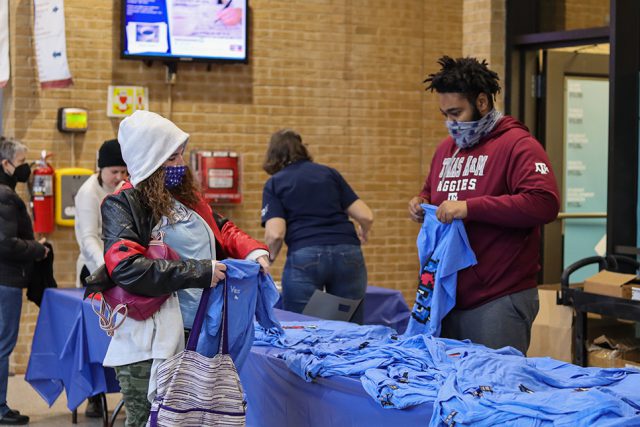 NE student Brianna Handy receives a shirt from a table handing them out. Photos by Alex Hoben/The Collegian