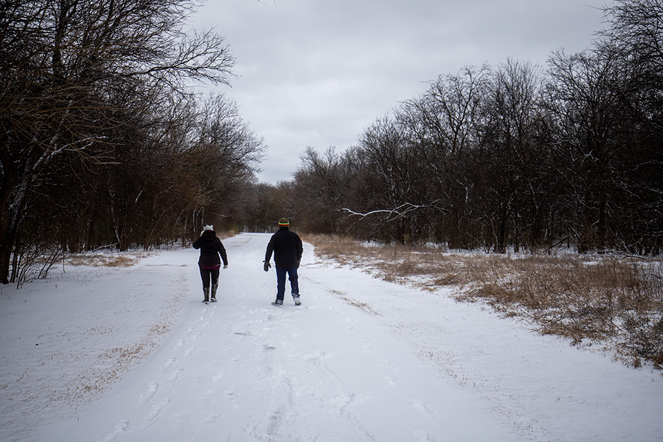 A mom and son walk on Fish Creek trail in Arlington during the storm Feb. 3. Joel Solis/The Collegian