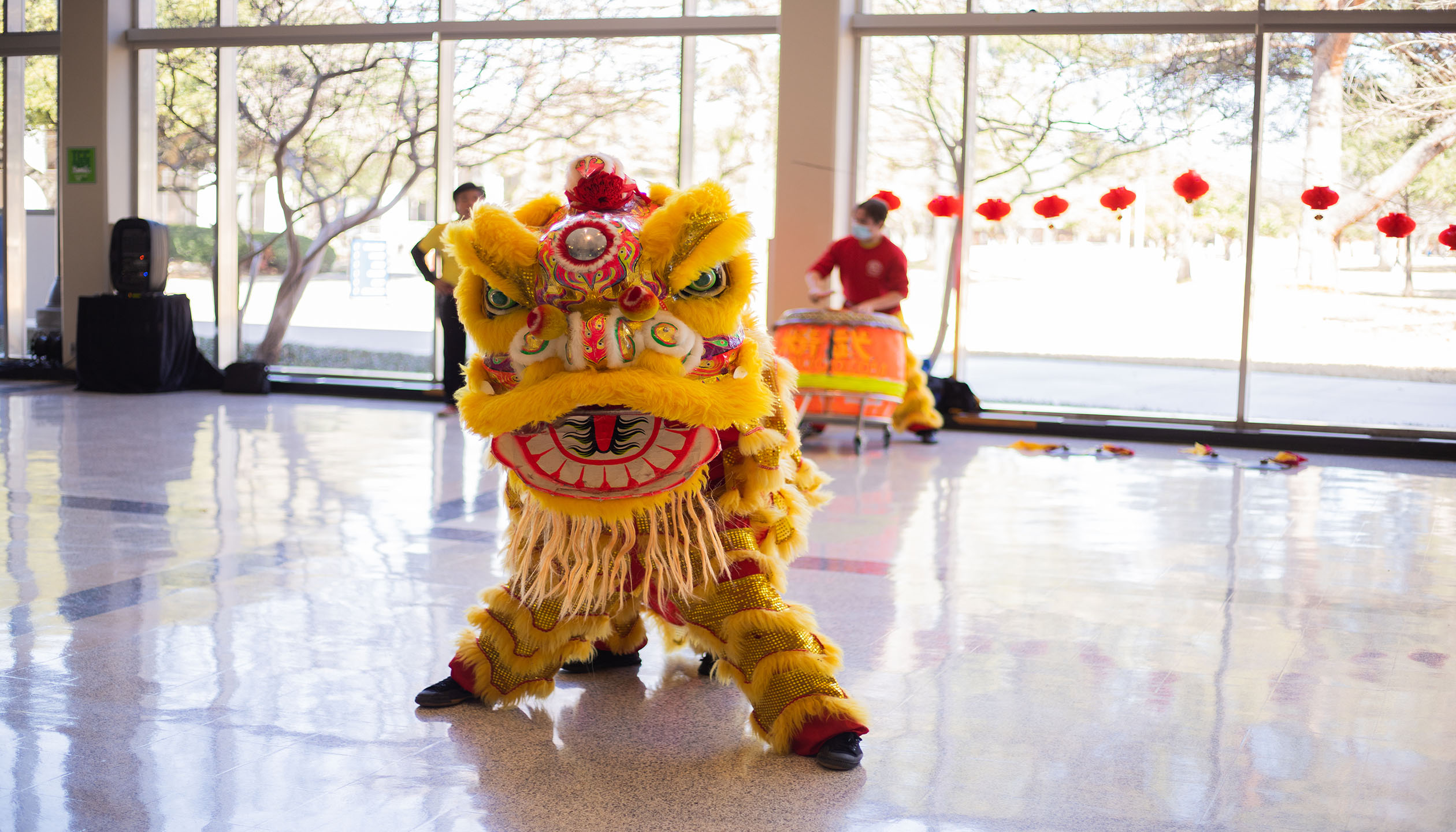 A traditional lion costume piloted by members of the J.K. Wong Kung Fu Tai Chi Academy parades through the halls of South Campus during its Lunar New Year event. Joel Solis/The Collegian