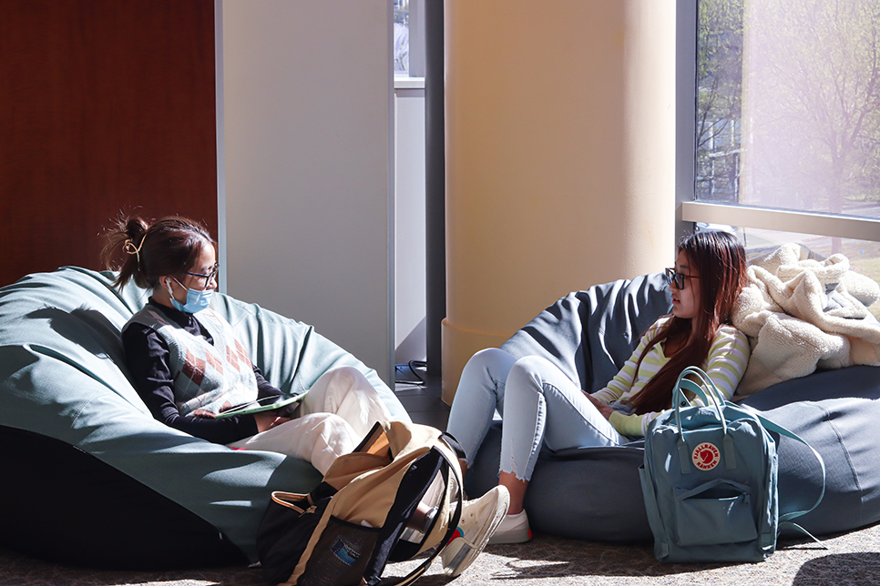 TR students Josie Nguyen and Vy Nguyen relax while talking on the beanbags provided in the TR cafeteria. Shot by Ariel Desantiago on 3/31 Ariel Desantiago/The Collegian