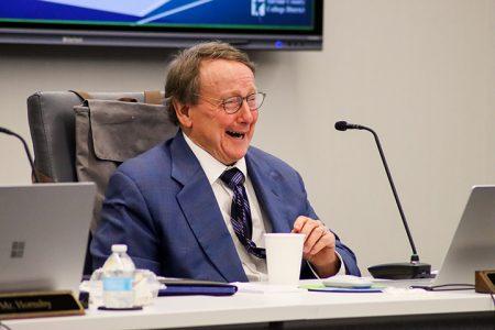 Trustee Bill Greenhill shares a laugh while at the Aug. 18 board meeting. Photo by Ariel Desantiago / The Collegian