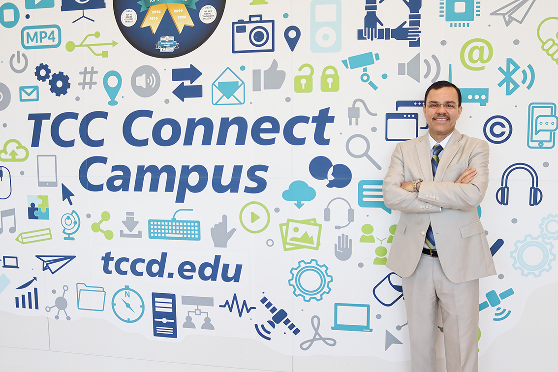 TCC Connect Campus president Carlos Morales stands in front of the sign leading into the Connect Campus’ building. It can be found on TR Campus. Photos by Alex Hoben/The Collegian