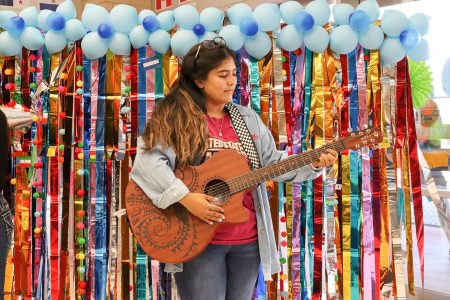 NW student and ALAS member Bertha Martinez plays her guitar “Luna” onstage during the Fiesta event. Photos by Ariel Desantiago/The Collegian