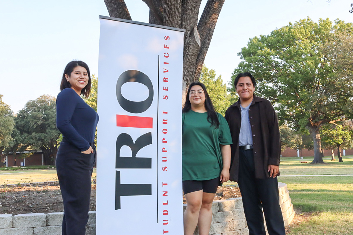 TRIO vibez hosts Lo Dominguez, Ana Ledezma and Johnny Sifuentes stands in front of the TRIO sign at the South campus. Ariel Desantiago/The Collegian