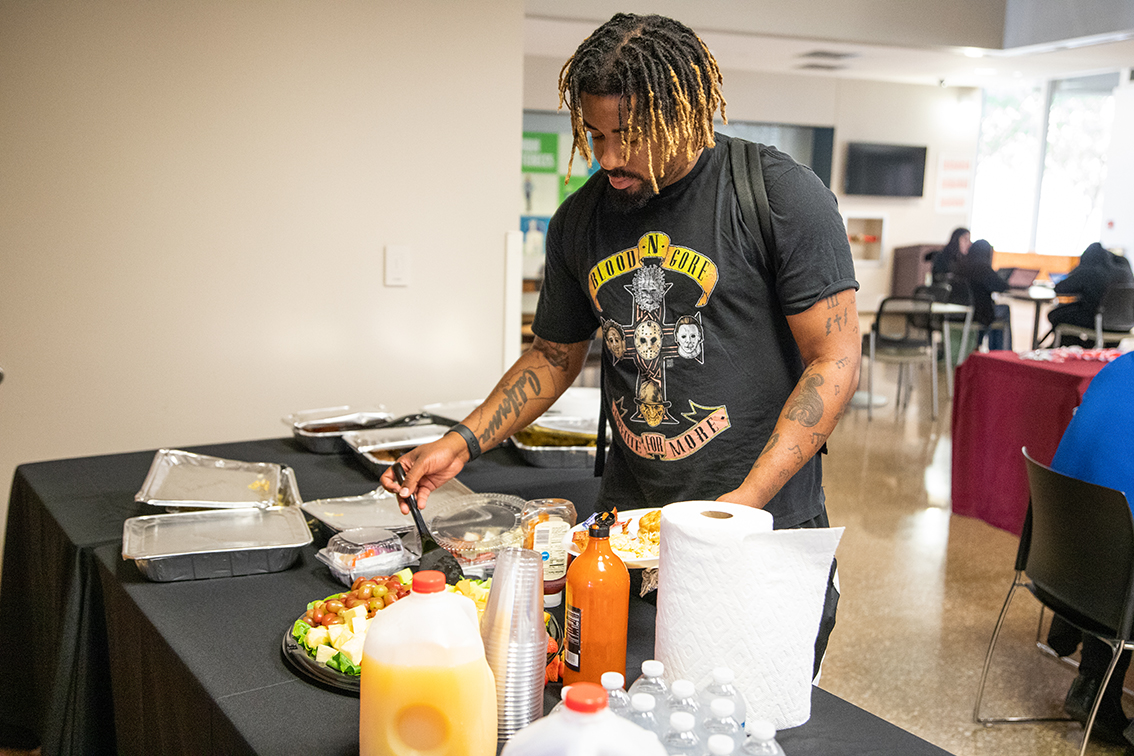 SE student Isaiah Moore peruses the buffet table that was provided for breakfast provided at the Veteran’s Breakfast on SE Nov. 9. Everyone was welcome to join. Joel Solis/The Collegian