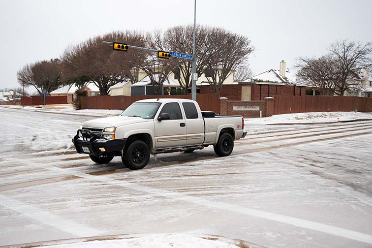 Silver truck driver passes by on the icy roads in Arlington during the 2023 Texas winter storm in the beginning of February. Joel Solis/The Collegian