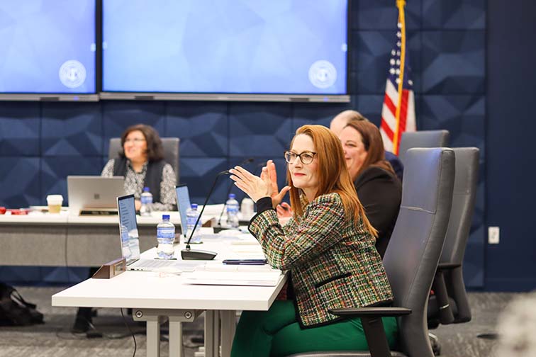 Trustee Shannon Wood applauds during the student presentations and stories at the February board of trustees meeting. Ariel Desantiago/The Collegian