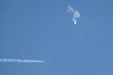 Debris falling from the sky after an alleged Chinese spy balloon was shot down by an F-22 military fighter jet over Surfside Beach, South Carolina, Saturday, Feb. 4, 2023. (Joe Granita/Zuma Press/TNS)