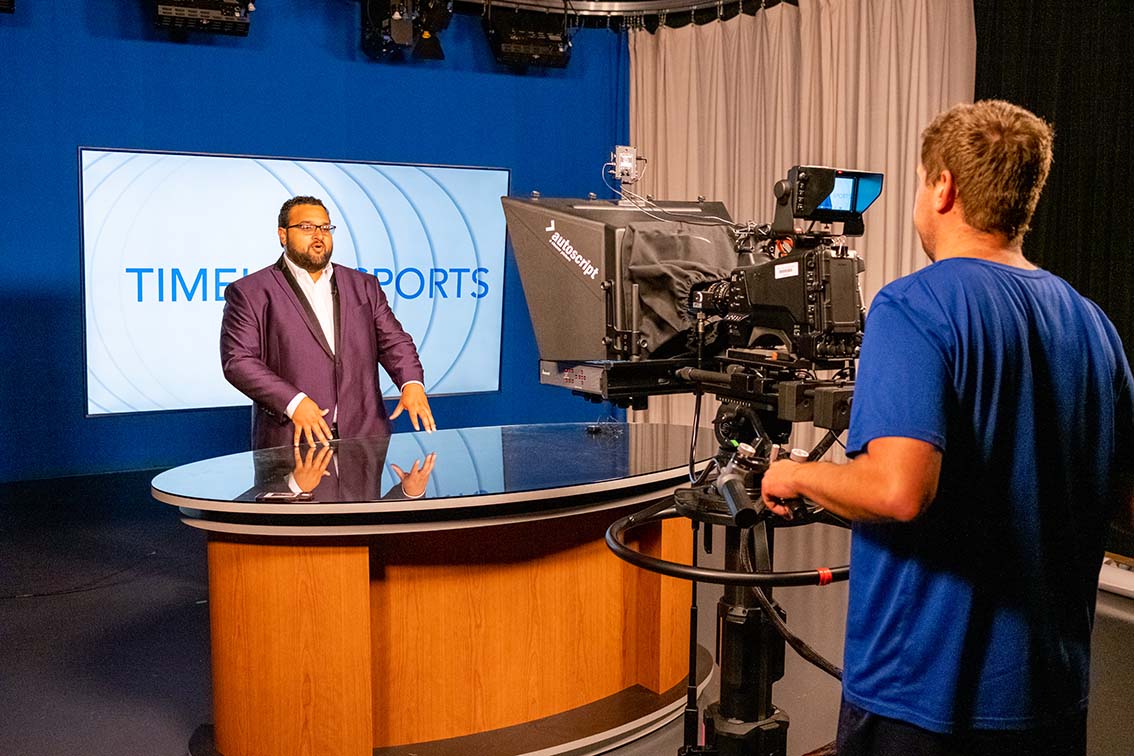 NE student Jason Holly presents the Timeline Sports segment of the TCC Newsfeed. Students can work on the Newsfeed to get on-the-job experience. KJ Means/The Collegian