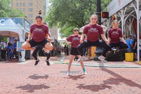 NW Dance Mosaic Project members Jesse Martinez, Andrea Faber and Audrey Derbyshire jump during their Main Street Arts Festival performance April 20. Alex Hoben/The Collegian