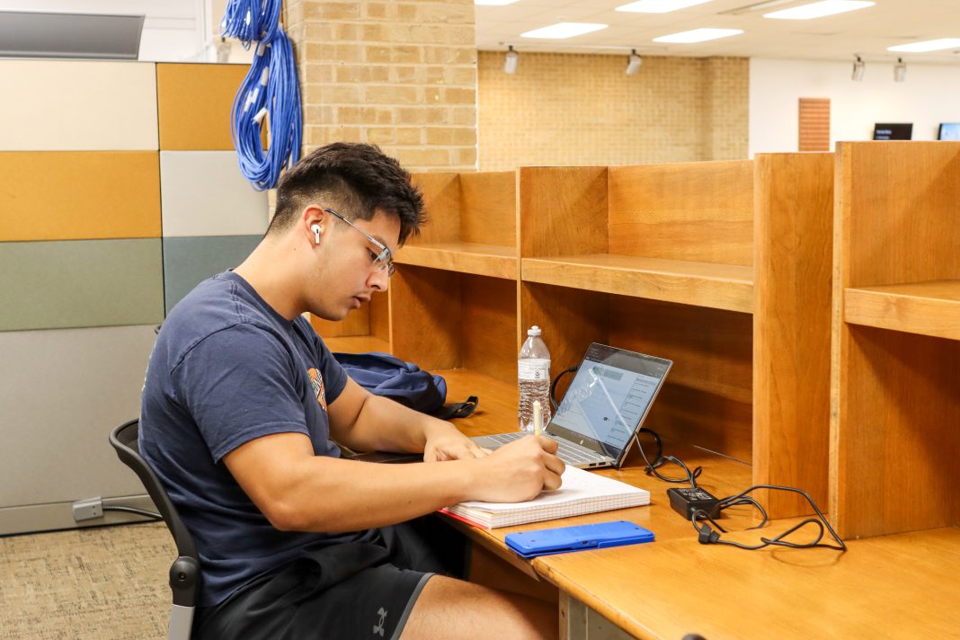 Ariel DeSantiago/The Collegian NE student Anthony Guerrero studies in the lower level of NLIB at the individual desks offered to students. The desks are a way for students to study unbothered.