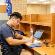 Ariel DeSantiago/The Collegian NE student Anthony Guerrero studies in the lower level of NLIB at the individual desks offered to students. The desks are a way for students to study unbothered.
