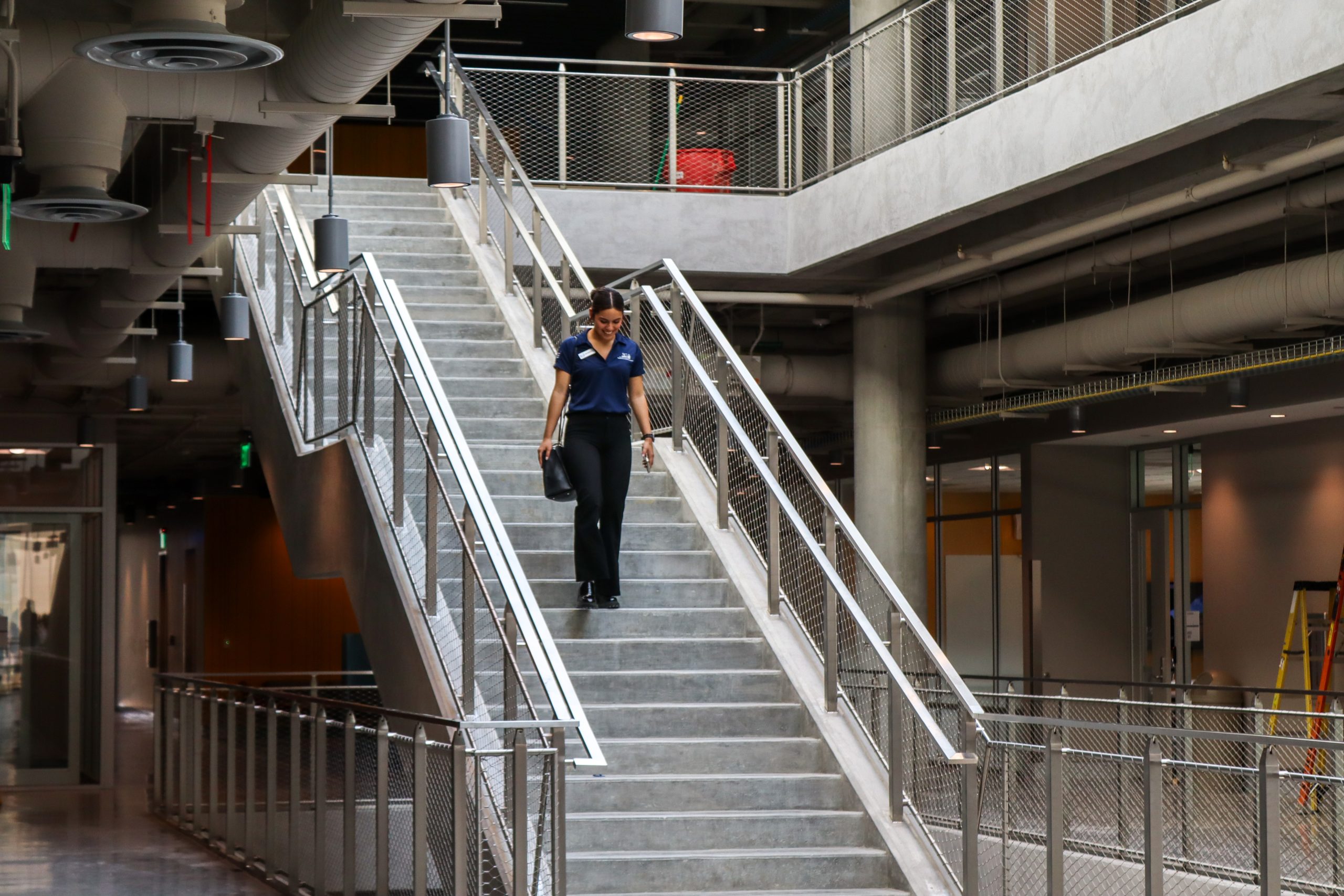 Hope Smith/The Collegian NW student and senate chair of NW SGA Mia Carrizales walks down a set of stairs in NW01 during the tour.