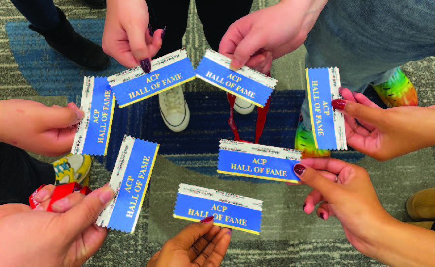 Olla Mokhtar/The Collegian Members of The Collegian hold out their ACP Hall of Fame indicator ribbons. The Collegian was inducted into the ACP Hall of Fame earlier this month.