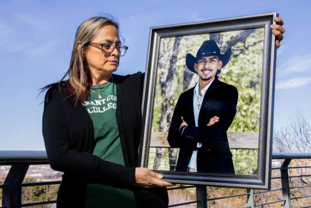 Alex Hoben/The Collegian TR ESOL instructor Lourdes Laguna holds the graduation photo of her son Luis Carlos Laguna Jr. The TCC student was murdered after a ranch party on November 18 in Fort Worth