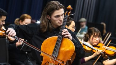 Alex Hoben/The Collegian High school student Riley Hylkema started playing the cello in first grade. He performed a cello solo during the concerto.
