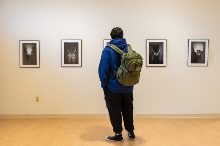Alex Hoben/The Collegian Included in "The Talk" exhibition is "The Cycle" series, which depicts multiple men with their hands behind their backs in handcuffs. The main model that Darough used in his photographs was actually himself.