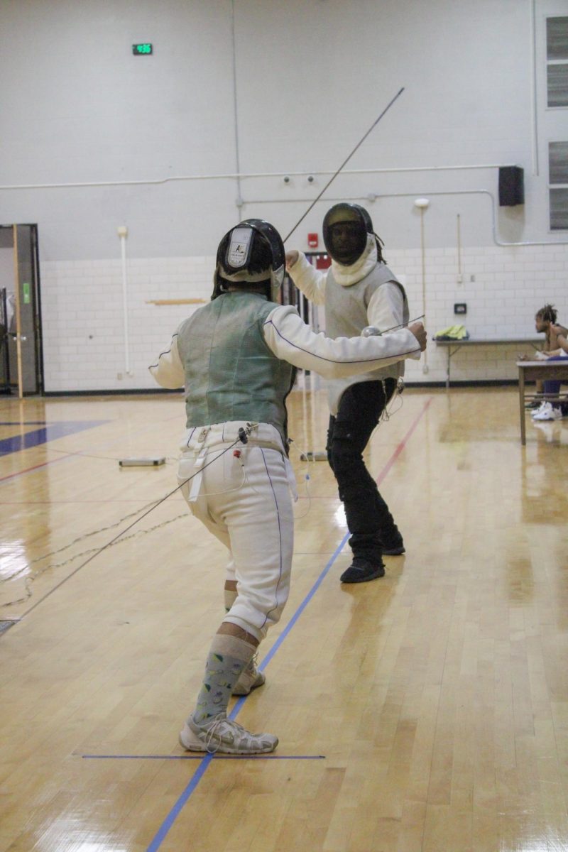 South Campus Student Anne Phan works on her reach during her lunges at a
fencing practice.